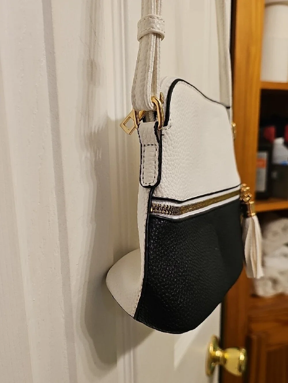 Two-Tone White and Black Crossbody Bag with Tassel Accent